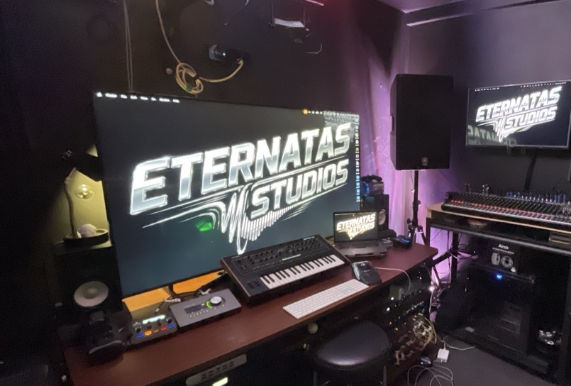 The Eternatas Studios logo across the room's screens, DMX fixtures glowing across the ceiling